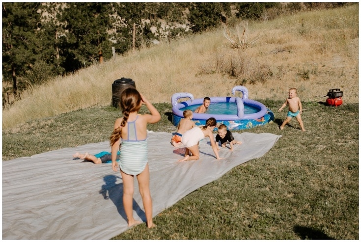 DIY plastic sheeting slip and slide with kids sliding