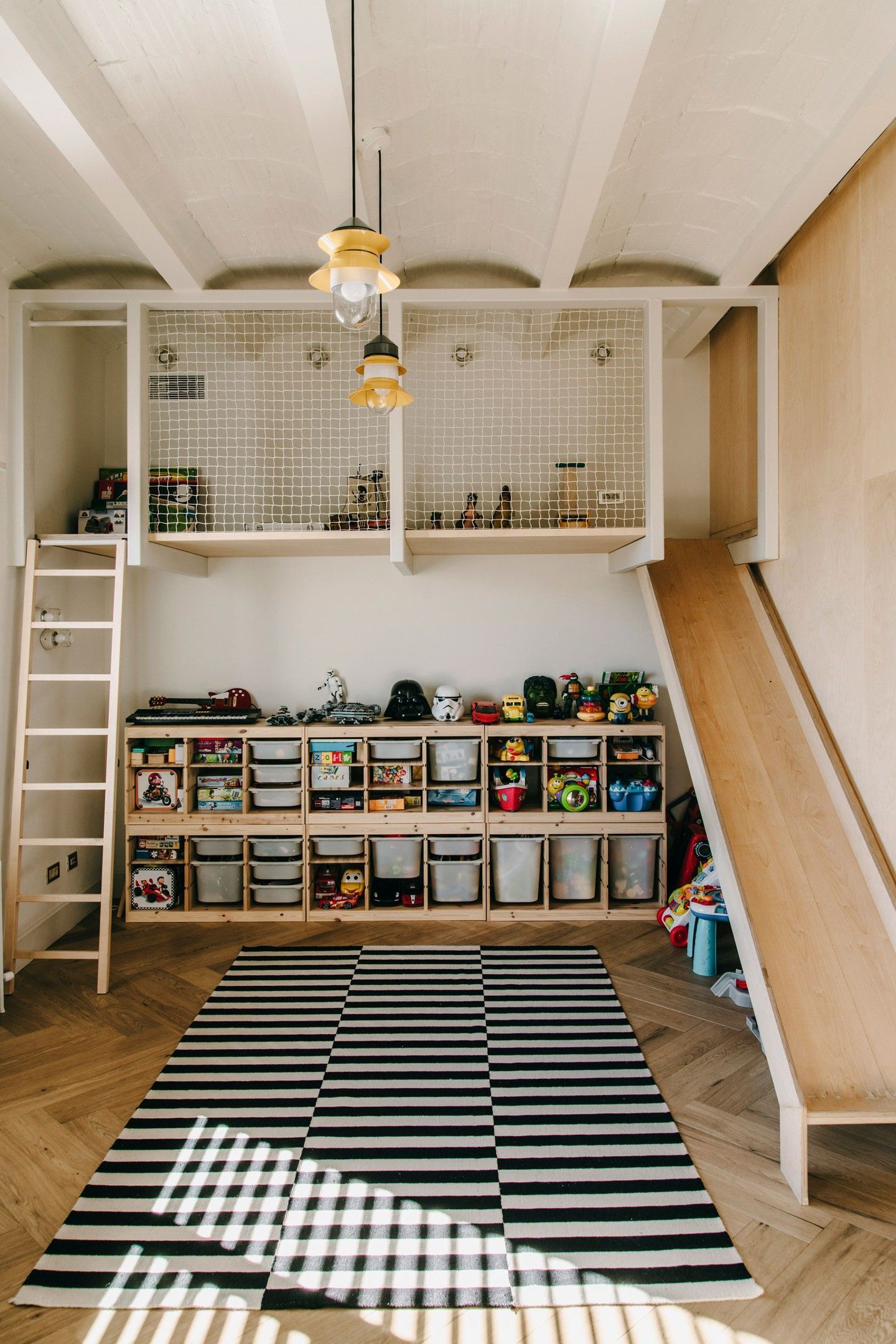 minimal indoor playground with ladder, netted loft, and slide