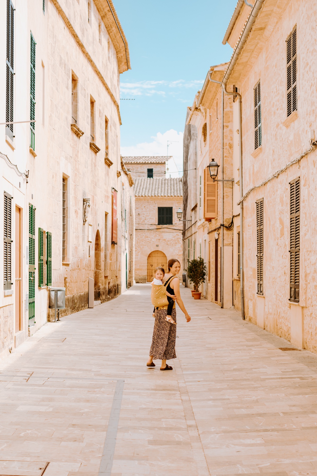 Visiting Alcudia with little kids in a toddler carrier.