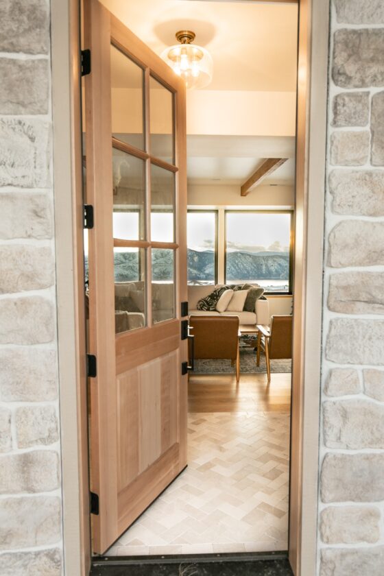 Farmhouse entry door with creative mines stone entryway and panoramic views. 
