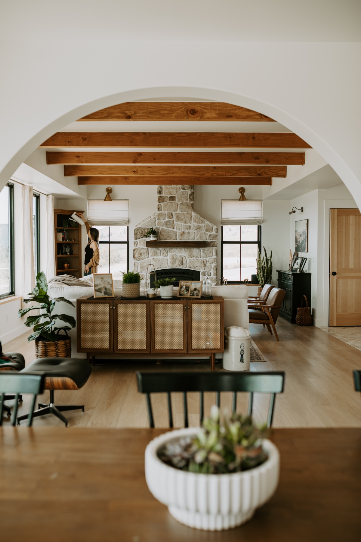 open euorpean farmhouse living room dining room with plants and wood beams